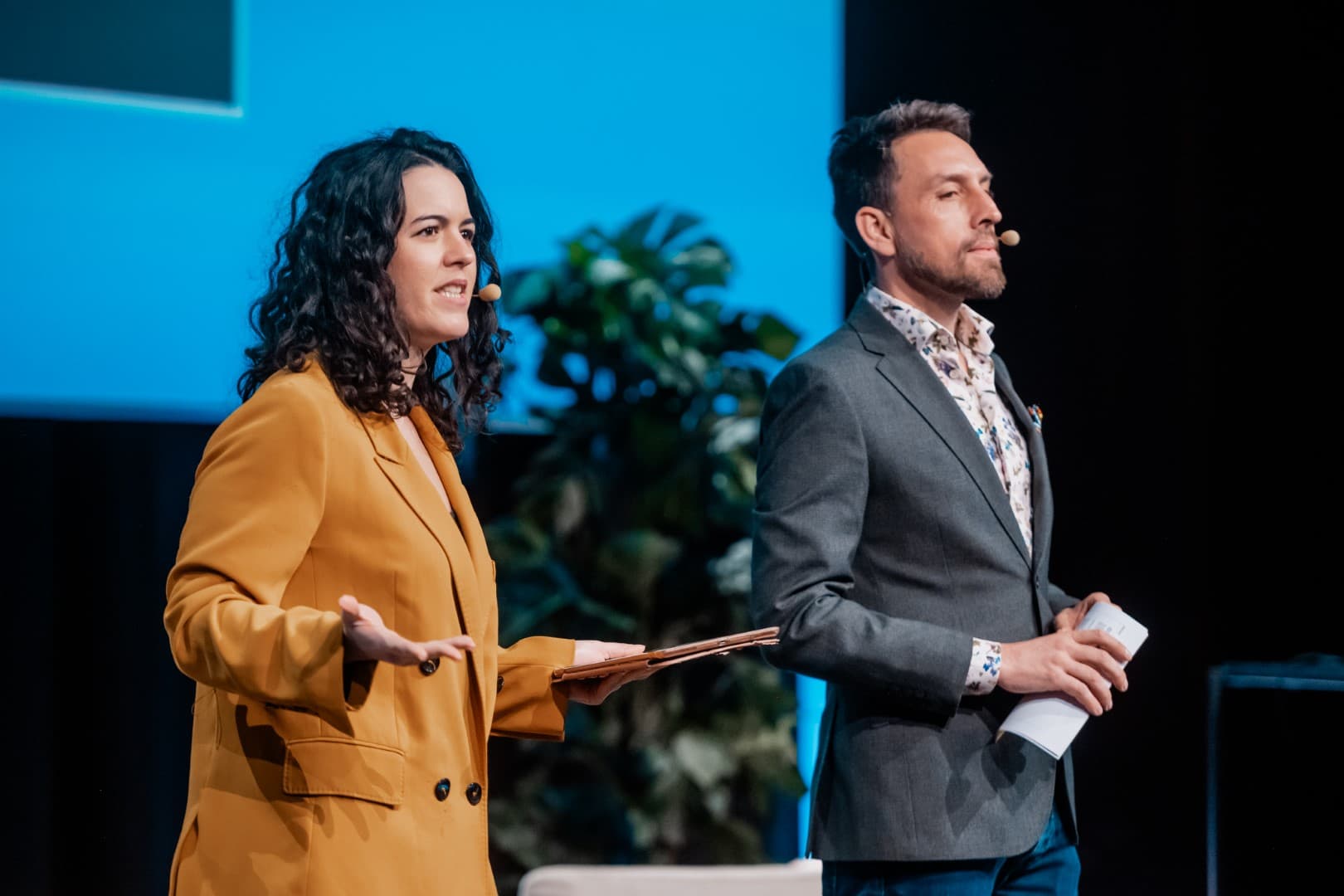 Professional moderators on stage at a European conference